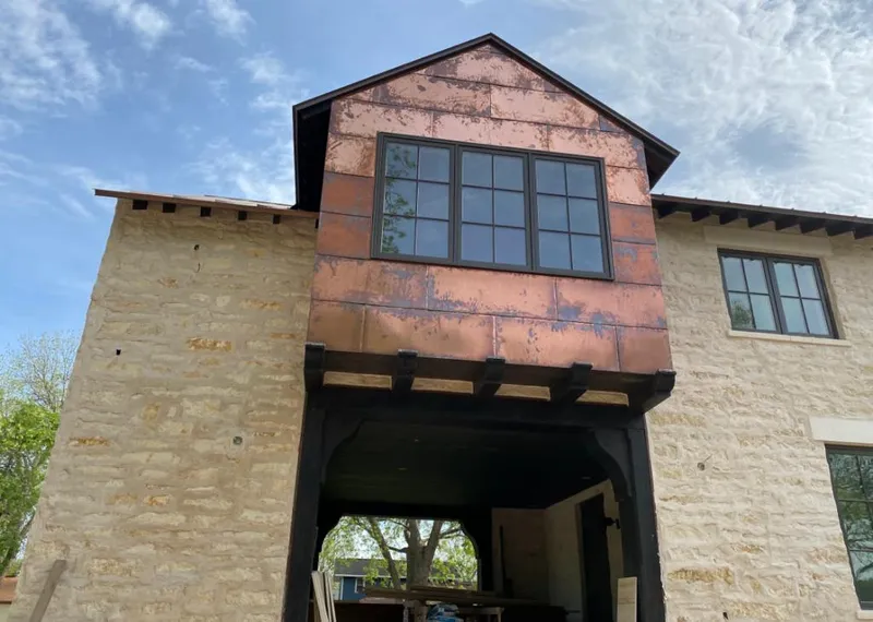 Copper metal panel facade on a stone building for Metal Roof Coating in Jasper
